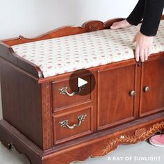 a baby crib is being worked on by a woman in black shirt and pink shoes