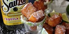 some sugared food and a bottle of tequila on a table with snow flakes