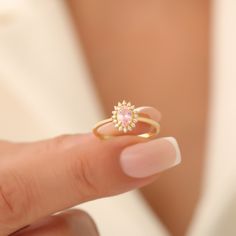 This exquisite 14K solid gold ring is a true embodiment of elegance and sophistication. At its center lies a beautiful pink tourmaline, renowned for its deep, rich color that captures the essence of timeless beauty. The  is surrounded by a cluster of sparkling real diamonds, each meticulously set to enhance the gemstone's natural brilliance and add a touch of luxurious sparkle. The combination of the pink tourmaline and diamonds creates a striking contrast against the warm, lustrous 14k solid go Pink Oval Birthstone Promise Ring, Formal Pink Oval Birthstone Ring, Pink Oval Gemstone Birthstone Ring, Pink Oval Ring For Proposal, Pink Oval Rings For Proposal, Oval Pink Proposal Ring, Pink Oval Birthstone Ring, Dainty Pink Oval Ring, Diamond Oval Ring