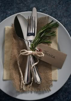 a white plate topped with silverware on top of a table