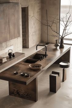 a kitchen with a sink, counter and stools