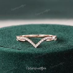 a diamond ring sitting on top of a green box