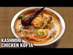 chicken kofta served in a bowl with sauce and garnish