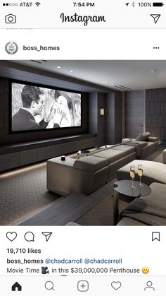 a screen shot of a movie room with two couches and a large screen tv