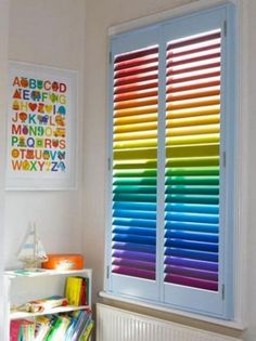 colorful blinds in the corner of a room with bookshelf and toys on it