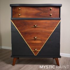 a black and brown chest of drawers with gold accents