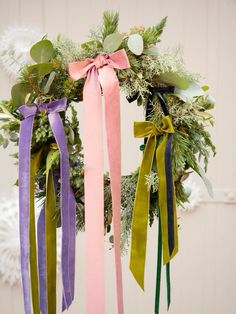 a wreath with ribbons hanging from it's sides