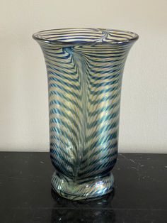 a glass vase sitting on top of a table