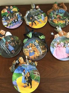 the plates have been decorated with pictures of people and animals on them, including children's characters