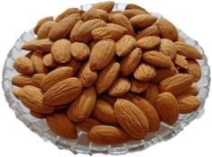 almonds in a glass bowl on a white background