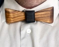 a close up of a person wearing a wooden bow tie