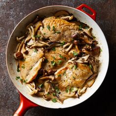 chicken with mushrooms in a red skillet on a table