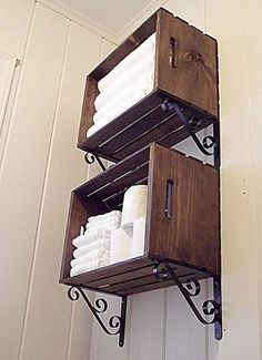 two wooden boxes are stacked on top of each other in the corner of a room