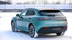 the rear end of a blue porsche cayenne parked on a snow covered parking lot