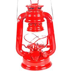 a red lantern that is sitting on top of a white surface with the light turned on