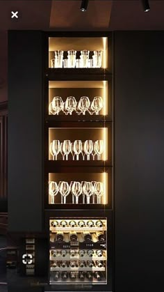 a display case filled with lots of wine glasses and plates on top of glass shelves