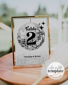 a table with a sign that says table 2 and has a disco ball on it