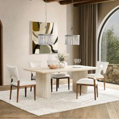 a dining room table with white chairs around it