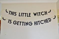 this little witch is getting hitched banner in black and gold on a white wall