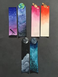 four bookmarks with different designs on them, each featuring an image of the moon and telescope