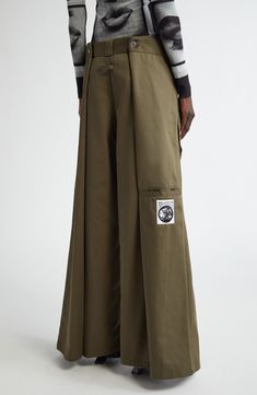 The maison's penchant for unconventional silhouettes is emphasized in the layered design of wide-leg pants that create a four-leg wrapped illusion. 30" inseam; 28" leg opening; 15 1/2" front rise; 17 1/2" back rise (size Medium) Zip fly with hook-and-bar closure Front welt pockets 65% polyester, 35% cotton Machine wash, dry flat Made in Portugal Designer Clothing