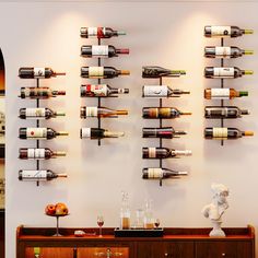 a wall mounted wine rack filled with lots of bottles