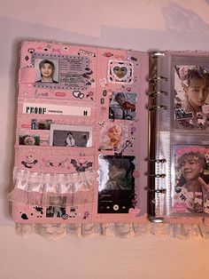 an open pink book with pictures and photos on it