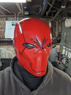 a person wearing a red mask in a room