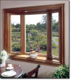 a dining room table with two vases on top of it next to a window