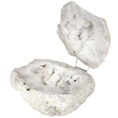 a rock with a pin sticking out of it's center, on a white background