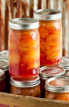 jars filled with oranges sitting on top of a table