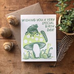 a card that says wishing you a very special birthday with a frog on the mushroom