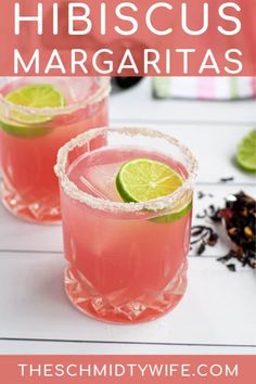 two pink margaritas with lime slices on the rim