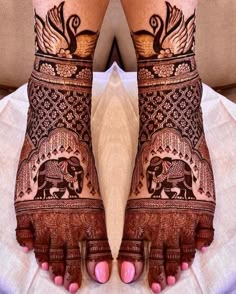 the feet are decorated with henna and elephants on their legs, as if they were from india