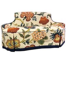 a white couch with flowers and leaves on it