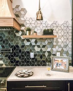 an instagramted photo of a kitchen with hexagonal tiles on the backsplash