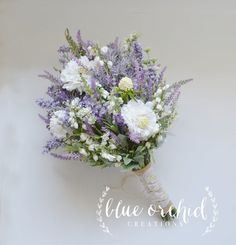 a bridal bouquet with white and purple flowers on the stems, tied in twine