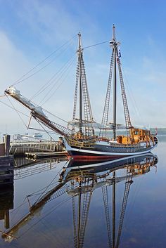 a large boat is docked at the dock