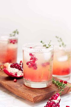 pomegranates are garnished with fresh herbs and served in glasses