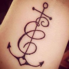 an anchor tattoo on the side of a woman's leg, with music notes