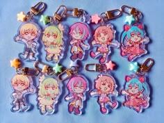 six keychains with cartoon characters on them sitting next to each other in front of a blue background