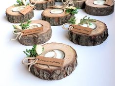 wooden slices with tags tied to them sitting on a table