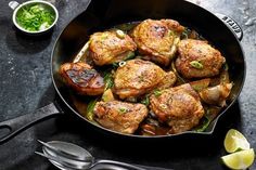 a pan filled with meat and vegetables on top of a table