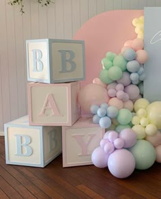 a baby shower with balloons and blocks on the floor