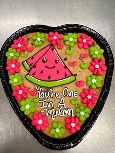 a heart shaped cookie with the words you're one in a melon on it