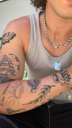 a man with many tattoos on his arm