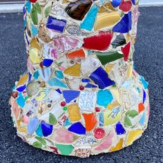 a multicolored vase sitting on the ground