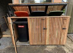 an outdoor storage area with chairs and trash cans