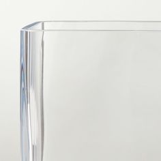 a clear glass vase with a thin line on the bottom and an angled corner at the top