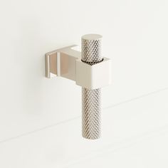 a toothbrush holder attached to a white wall